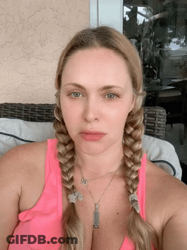 Woman In Pink Tank Top With Braids And I Love You Pendant GIF