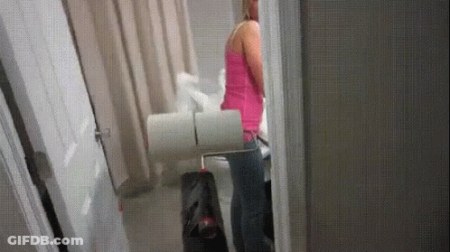 Woman In Pink Tank Top With Toilet Paper GIF