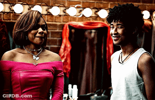 Woman In Pink Top And Man In White Tank Top Smiling GIF