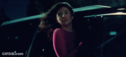Woman In Pink Top Sitting In Back Of Car GIF