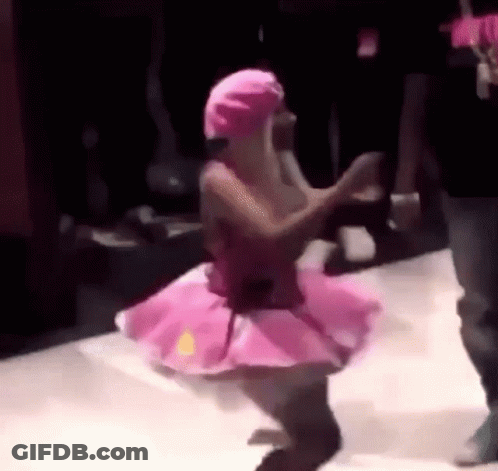 Woman In Pink Tutu Dancing In Dark Room GIF