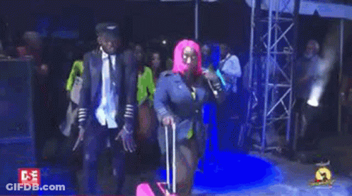 Woman In Pink Wig Walking With Pink Suitcase GIF