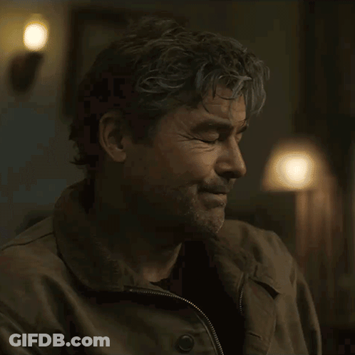 Woman In Plaid Cardigan Smiling In Classroom GIF
