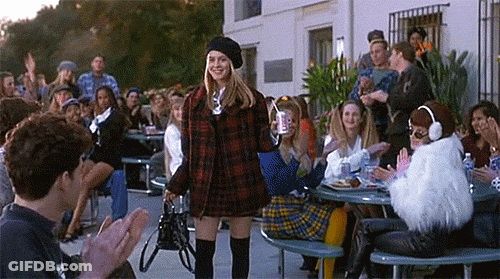 Woman In Plaid Dress And Beret Before Applauding Crowd GIF