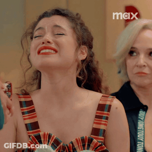 Woman In Plaid Dress Crying With Max Logo GIF