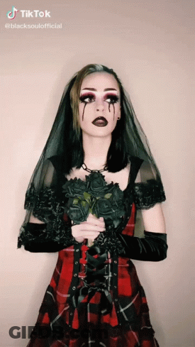 Woman In Plaid Dress Holding Black Roses GIF