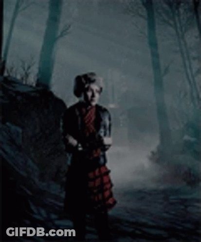 Woman In Plaid Dress In Foggy Forest GIF