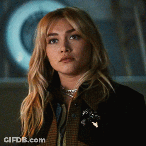 Woman In Plaid Jacket And Necklace GIF