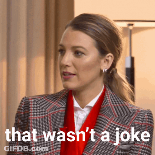 Woman In Plaid Jacket And Red Scarf Says That Wasn't A Joke GIF