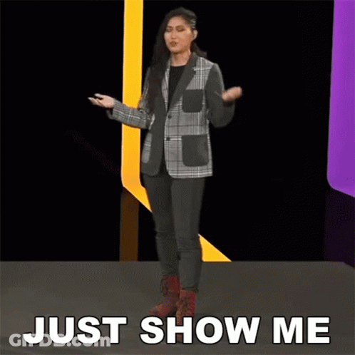 Woman In Plaid Jacket On Stage Saying Just Show Me GIF
