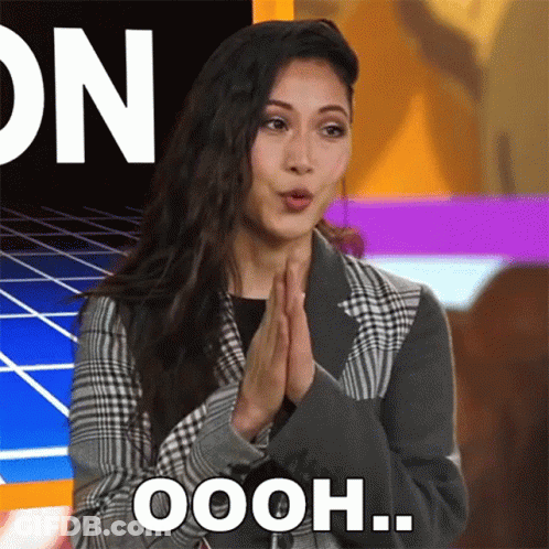 Woman In Plaid Jacket Saying Oooh GIF