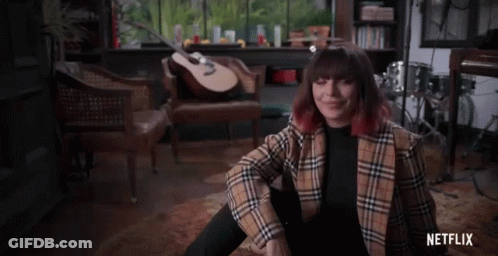 Woman In Plaid Jacket With Guitar And Netflix GIF