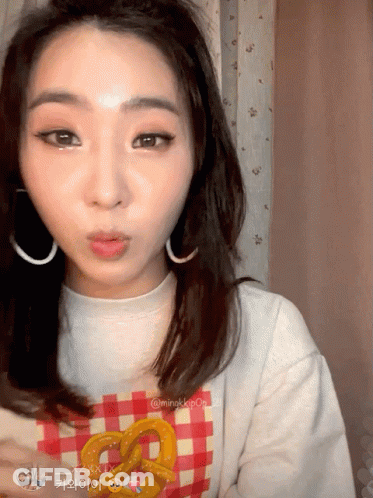 Woman In Plaid Pretzel Shirt Making Face GIF