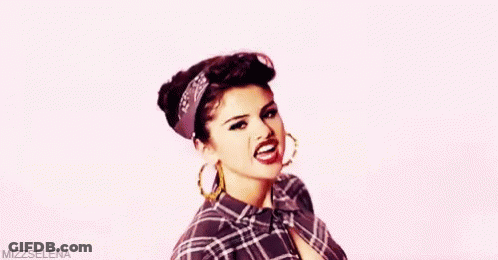 Woman In Plaid Shirt And Hoop Earrings Making Funny Face GIF