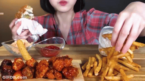 Woman In Plaid Shirt Eating French Fries And Chicken GIF