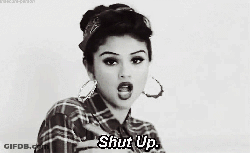 Woman In Plaid Shirt Giving Middle Finger Saying Shut Up GIF