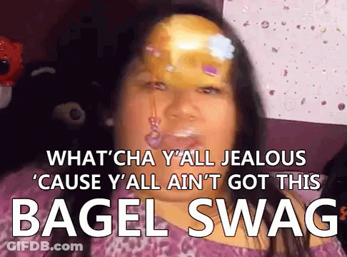 Woman In Plaid Shirt Holding Bagels Says We Got Bagels GIF