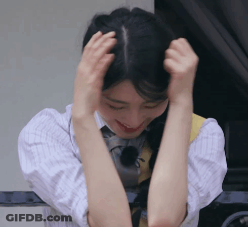Woman In Plaid Shirt Holding Hair GIF
