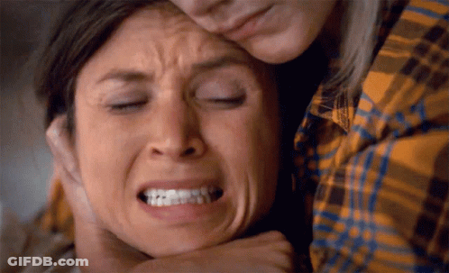 Woman In Plaid Shirt Holding Other Woman's Face GIF