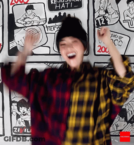 Woman In Plaid Shirt In Front Of Cartoon Wall GIF