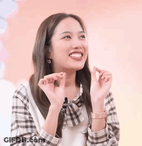 Woman In Plaid Shirt Making Heart With Hands GIF