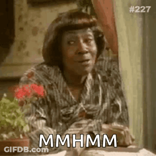 Woman In Plaid Shirt Saying Mmhmm GIF
