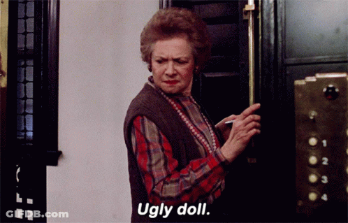 Woman In Plaid Shirt Saying Ugly Doll GIF