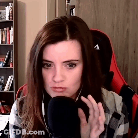 Woman In Plaid Shirt Sitting At Microphone With Letter A On Chair GIF