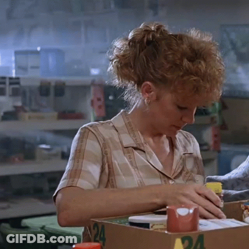 Woman In Plaid Shirt Sitting At Table With Box Number 24 GIF