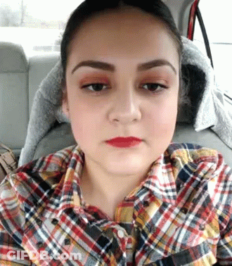 Woman In Plaid Shirt Sitting In Back Seat Of Car GIF