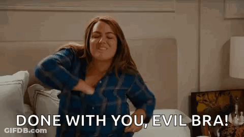 Woman In Plaid Shirt Sitting On Bed GIF