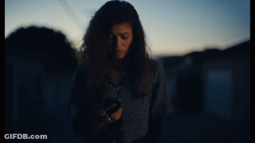 Woman In Plaid Shirt Talking On Cellphone GIF