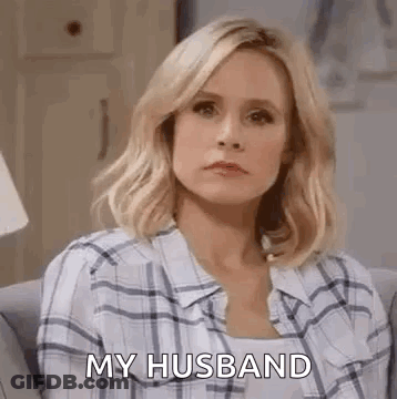 Woman In Plaid Shirt Talking To Husband On Couch GIF