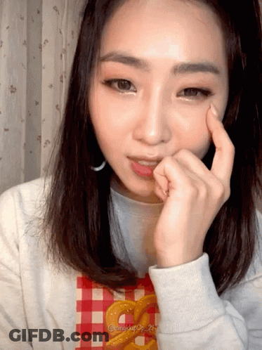 Woman In Plaid Shirt With Pretzel GIF