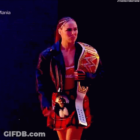 Woman In Plaid Skirt Holding Wrestling Belt GIF