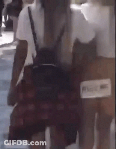 Woman In Plaid Skirt Walking With Backpack GIF