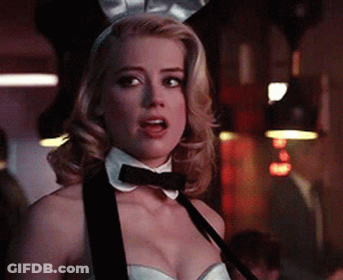 Woman In Playboy Bunny Costume Looking At Camera GIF