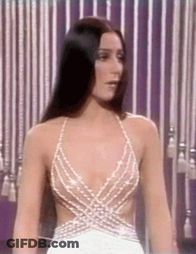 Woman In Plunging White Dress With Striped Curtain GIF