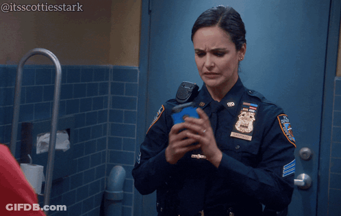 Woman In Police Uniform Holding Cell Phone Saying Ugh So Much Porn GIF