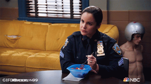 Woman In Police Uniform Sitting At Table GIF