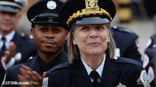 Woman In Police Uniform Smiling Next To Man GIF