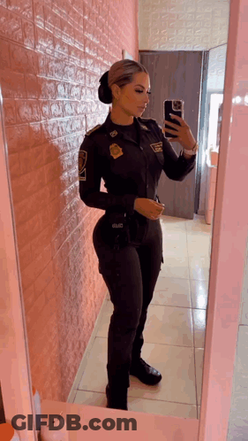 Woman In Police Uniform Taking Selfie In Mirror GIF