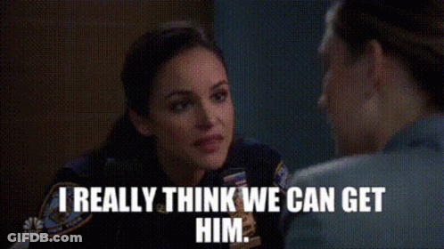 Woman In Police Uniform Talking To Man In Prison Cell GIF