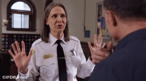 Woman In Police Uniform Talking To Man In Prison Cell GIF