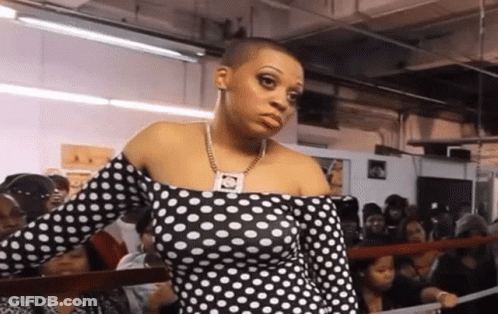 Woman In Polka Dot Dress In Crowd GIF