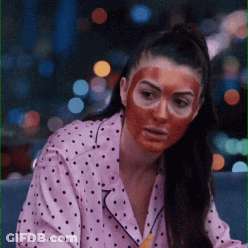 Woman In Polka Dot Pajama Shirt And Red Face Mask GIF
