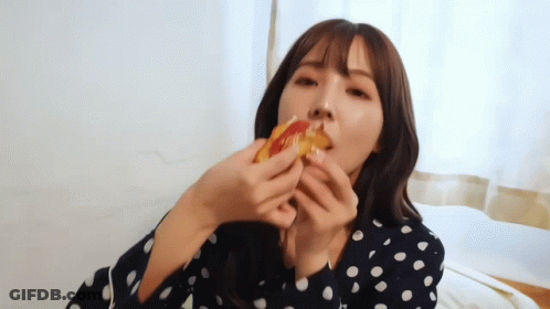 Woman In Polka Dot Shirt Eating Pizza GIF