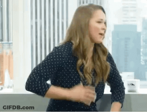 Woman In Polka Dot Shirt Holding Water GIF