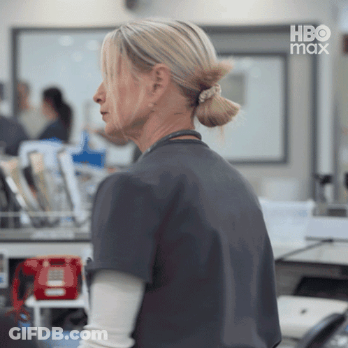 Woman In Ponytail In Front Of HBO Max Logo GIF