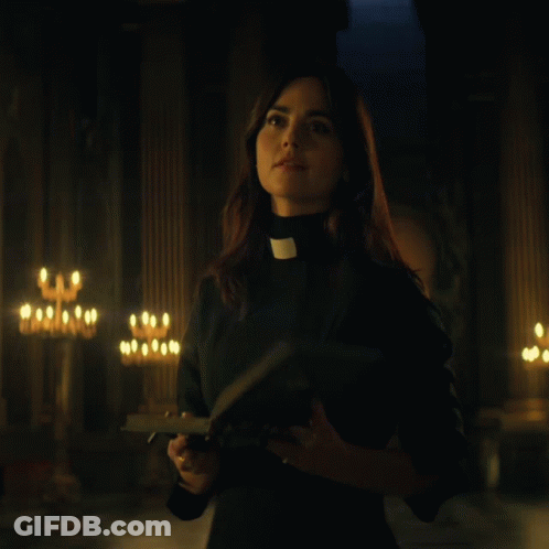 Woman In Priest Collar Holding Bible GIF